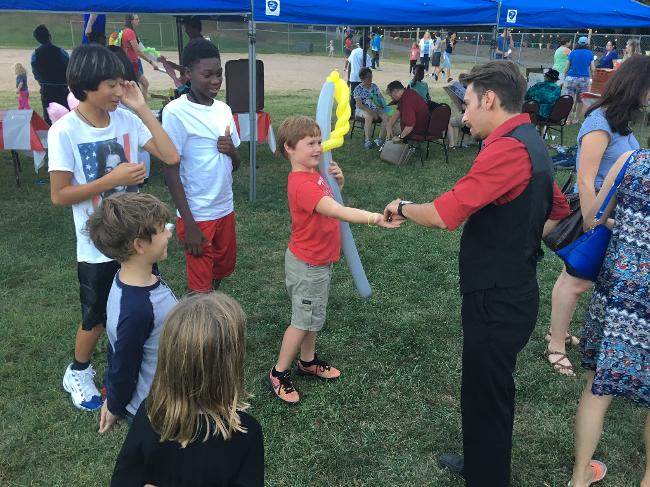 Elliot the Entertainer strolling magician at a festival