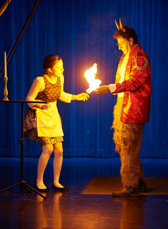 Professor Leland performing fire and magic in a show