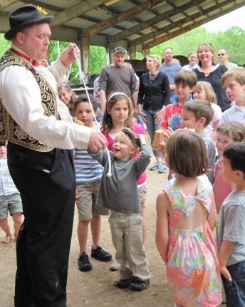 Oh My Gosh Josh performs magic at a festival